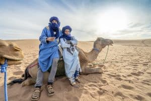 Bedouin mannen poseren met een kameel in de Sahara in Marokko